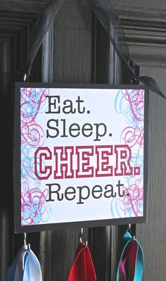 a sign that says eat sleep cheer repeat