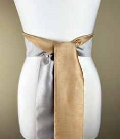 "Wide Textured Gold &  Silver Sash Belt  Silver and Gold Dupioni Sash  Two-Tone Dress Sash  Fabric Belt  Silver Gold Wedding  Add sophistication and rich texture to your special occasion outfit with this two-tone Satin Swank® dupioni waist sash. Depending on your waist size and the length you choose (75 and 90 inch lengths available), you can wrap this sash around your waist once or twice. You decide whether to tie the sash in a bow or a simple knot with long-hanging tails. Tie in front, in back Silver Gold Wedding, Occasion Outfit, Waist Sash, Dress Sash, Sash Belts, Special Occasion Outfits, Sash Belt, Fabric Belt, Suspender Belt