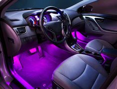 the interior of a car with purple lights