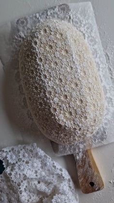 a large piece of bread sitting on top of a white surface next to a paper towel