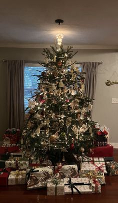 a decorated christmas tree with presents under it