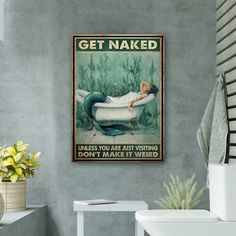 a bathroom with a sink, toilet and bathtub poster on the wall above it