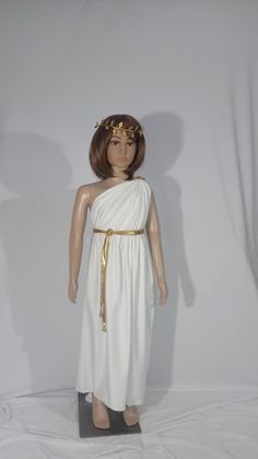 a mannequin wearing a white dress with gold trims and a golden belt