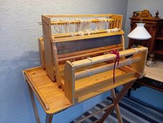 an old fashioned sewing machine sitting on top of a wooden table