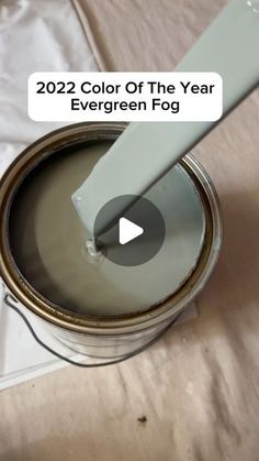 a paint can with a white spatula in it and the words, 2020 color of the year evergreen fog