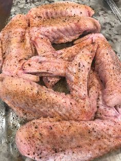 raw meat sitting on top of a metal pan