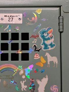 the back of a refrigerator covered in stickers and magnets with numbers on it