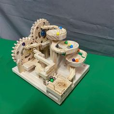 a wooden model of a machine with gears