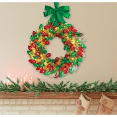 a christmas wreath is hanging on the mantle