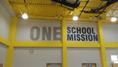 the inside of a school building with one mission sign