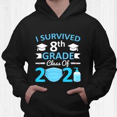 a man wearing a black hoodie with the words i survived 8th grade class of 2020 printed on it