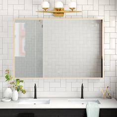 a bathroom with two sinks and a large mirror on the wall next to each other