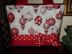 a red and white christmas ornament tote bag with polka dots on it