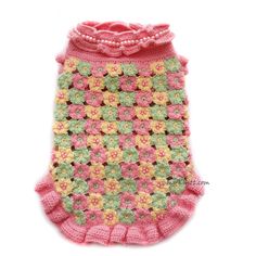 a crocheted pink and green dog sweater with flowers on the front, made to look like an afghan