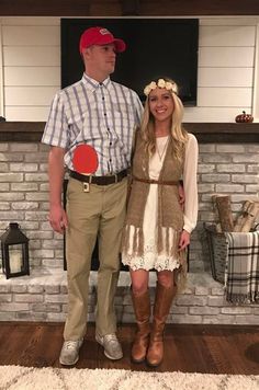 a man and woman standing in front of a brick wall