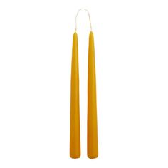 two yellow candles sitting next to each other