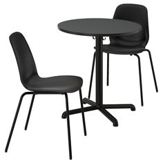 two black chairs and a round table on a white background