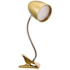 a gold desk lamp with a white light on it