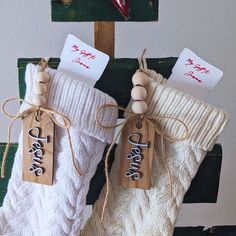 two christmas stockings with tags hanging from them