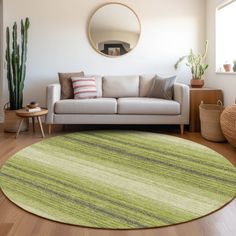 a living room with a white couch and green rug