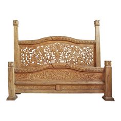 a wooden bed frame with intricate carvings on it