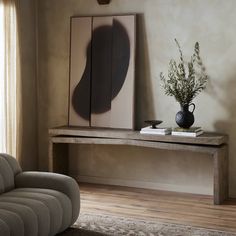 a living room with a couch, table and mirror