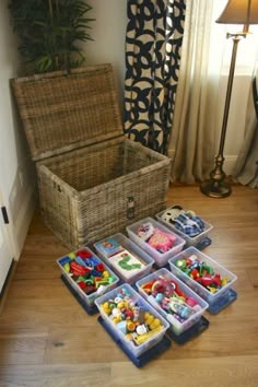 an open suitcase sitting on top of a wooden floor next to toy blocks and toys