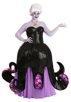 a woman in a black and purple dress is standing on an octopus shaped object with her hands out