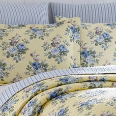 a bed with blue and yellow flowers on it