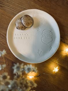 a white plate topped with two cookies on top of a wooden table