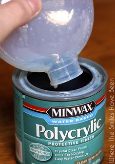 a can of polycrylic with a plastic ball in it's top