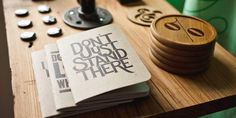 several wooden coasters sitting on top of a table next to a bottle opener and other items