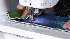 someone using a sewing machine to sew fabric