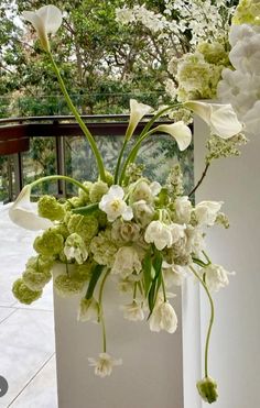 there is a vase with white flowers in it