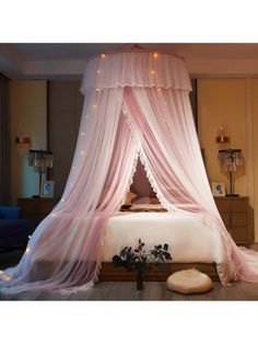 a bed with a pink canopy over it in a room filled with furniture and lights