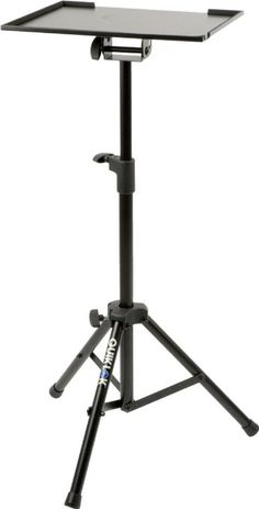 a tripod with a laptop on it and a light stand in front of it