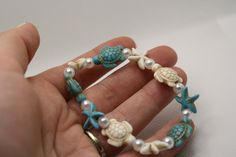 Blue and white bracelet with Turtle bead and Starfish charms made of synthetic turquoise beads and faux pearls on a strong and stretchy elastic string. Bracket Ideas, Blue And White Bracelet, Pulseras Ideas, Floss Bracelets, Kandi Inspo, Coconut Dream, Cherry Necklace, Trendy Bracelet, Multi Coloured Necklaces