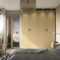 a bedroom with a large bed and wooden closets in the wall next to it