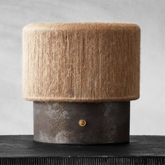 a brown and black pot sitting on top of a wooden table