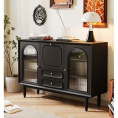 a black cabinet with glass doors in a living room