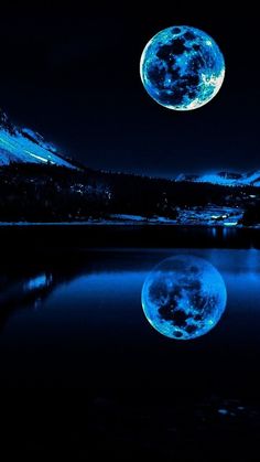 the full moon is shining brightly in the night sky over a body of water with mountains behind it