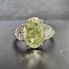 3.55 Carat GIA Fancy Light Brownish Greenish Yellow Oval Cut Diamond VVS2 Clarity 0.60 Carat Half Moons Handmade in 18k White Gold GIA Certified Luxury Green Marquise Diamond Ring, Gia Certified Oval Diamond Ring, Gia Certified Oval Diamond Ring Fine Jewelry, Luxury Oval Diamond Ring, Luxury Yellow Oval Rings, Luxury Oval Diamond Cut Rings, Green Oval Diamond Ring With Vvs Clarity, Luxury Pear-shaped Three Stone Rings, Exquisite Green Oval Diamond Ring