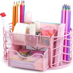 a pink container filled with lots of different colored pens and pencils on top of each other