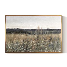 a painting hanging on the wall above a field with wildflowers and trees in the distance