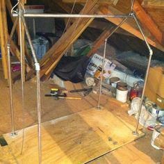 an attic with wood flooring and exposed walls, including paint cans and other items