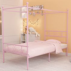 a pink metal bed frame in a bedroom