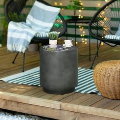 a table with a potted plant on top of it next to a wicker chair