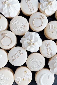 some cookies with wedding rings and flowers on them