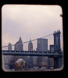 a view of the brooklyn bridge through a window