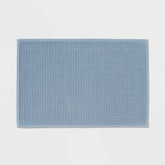 a blue bath mat on a white background